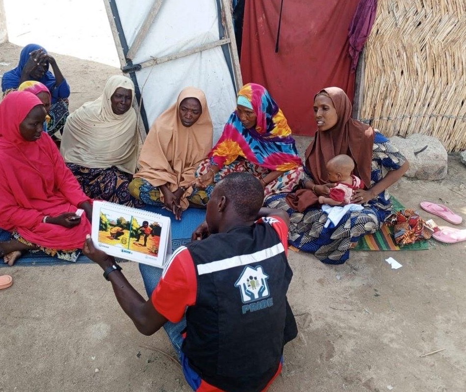 A PRIDE frontline worker running a cholera-prevention session with households in Borno State, Nigeria.